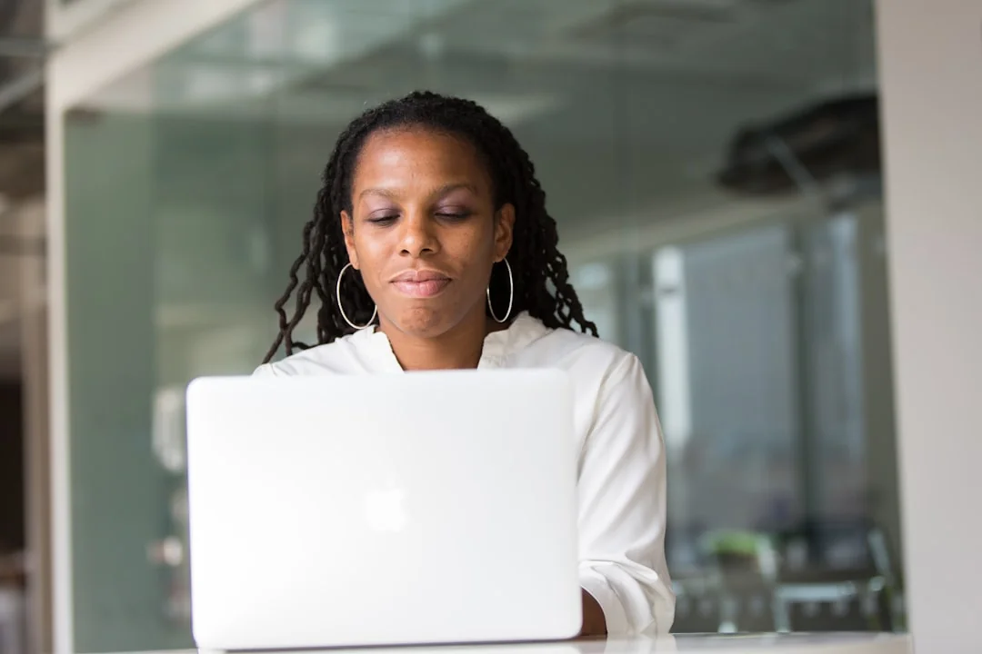 Close-up of a woman working on a digital marketing project in a home office setting.